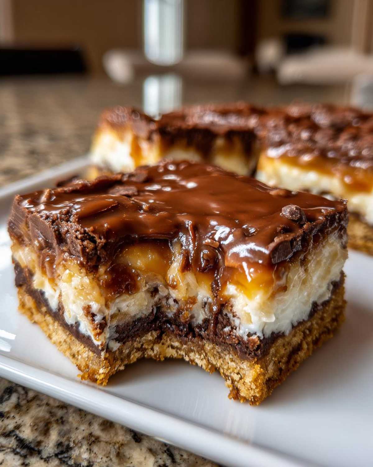 A close-up of a decadent, layered magic cookie bars square with a bite taken out, showing the crust, coconut, and thick chocolate topping.