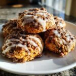 A stack of soft coffee cake cookies topped with cinnamon streusel and a white vanilla glaze.