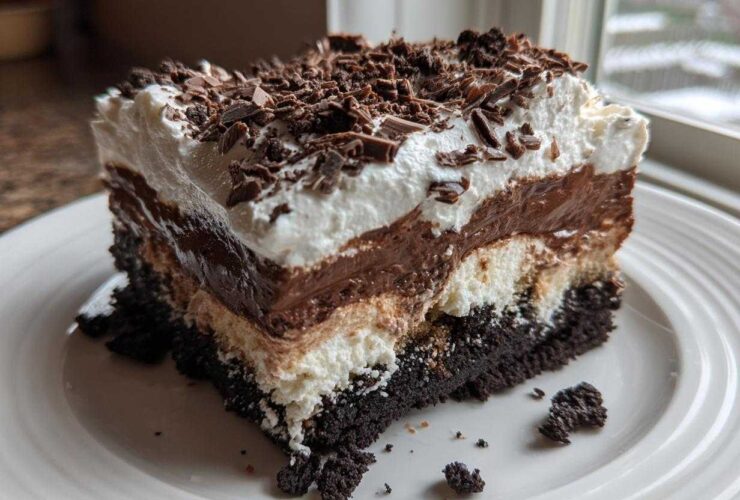 A rich, layered slice of Baileys Chocolate Cheesecake Trifle topped with whipped cream and chocolate shavings.