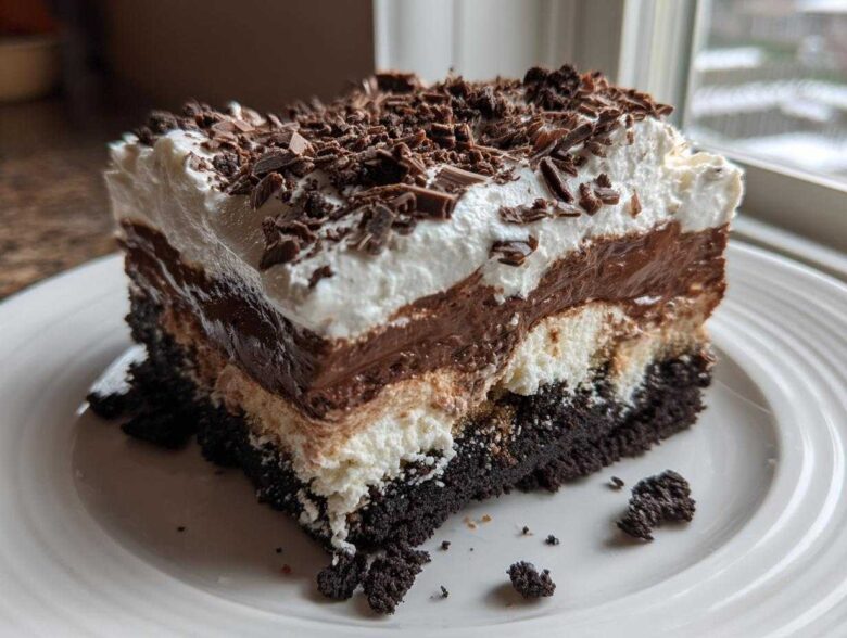 A rich, layered slice of Baileys Chocolate Cheesecake Trifle topped with whipped cream and chocolate shavings.