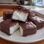 A stack of homemade chocolate covered bars with a fluffy white filling, showing the texture of this cool whip candy.