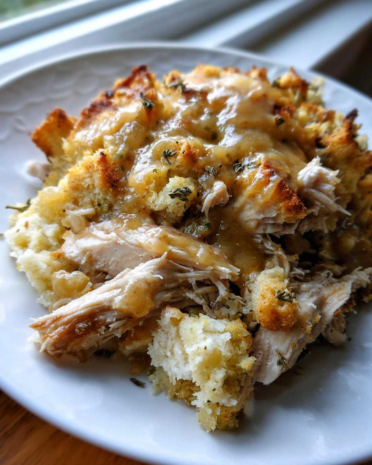Close-up of shredded, moist chicken mixed with savory stuffing, part of the crock pot chicken and stuffing recipe.