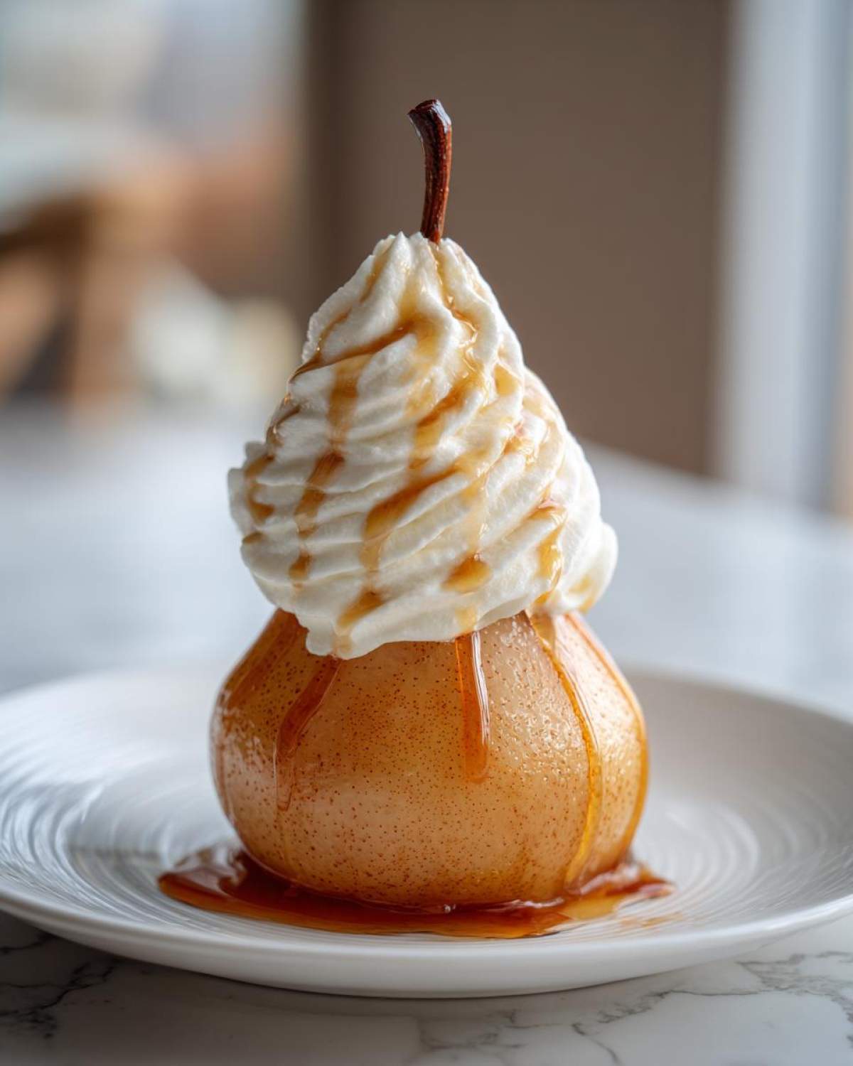 A single, beautifully poached pears topped with a swirl of whipped cream and caramel drizzle.