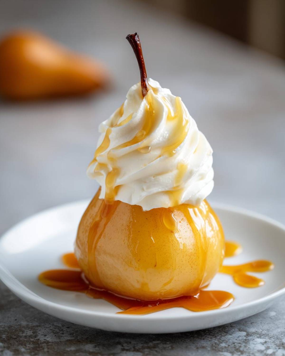 A beautifully presented poached pears dessert topped with a swirl of whipped cream and drizzled with caramel sauce.