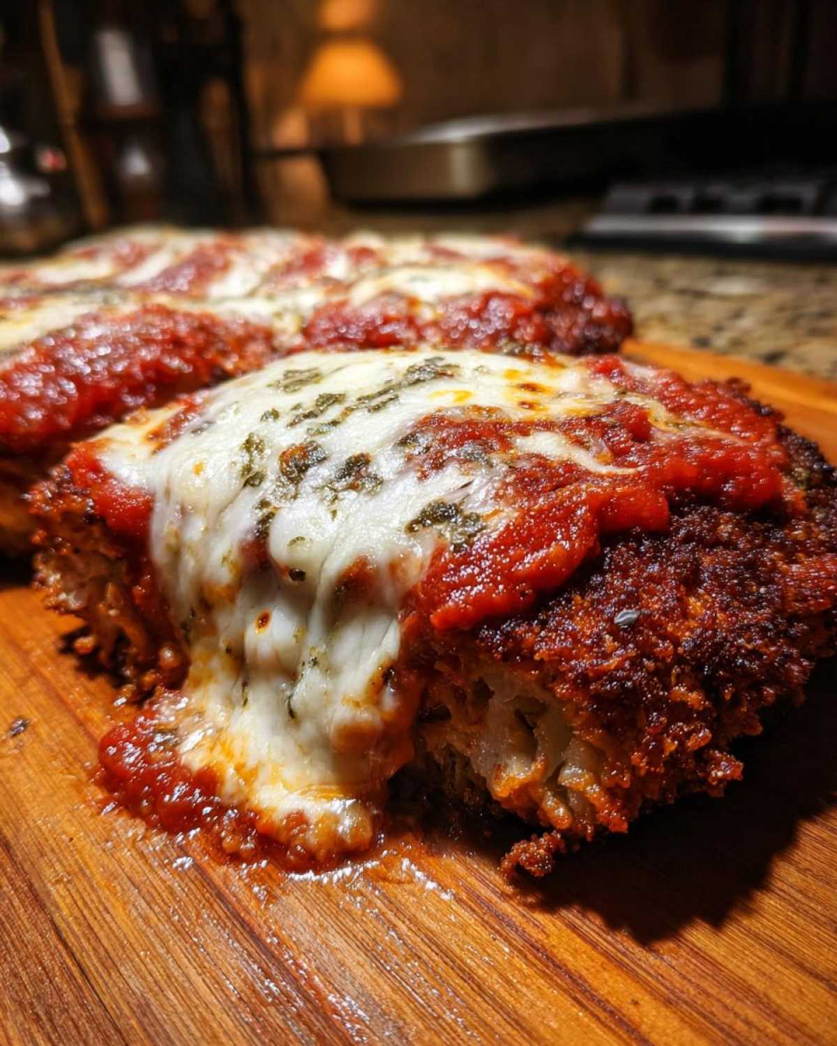 Close-up of crispy Air Fryer Chicken Parmesan topped with melted mozzarella cheese and marinara sauce.