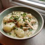 Close-up of a bowl of Creamy Chicken Gnocchi Soup featuring tender gnocchi, shredded chicken, and fresh parsley.