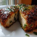 Cross-section of a thick, juicy Crispy Air Fryer Pork Chop with a golden-brown crust and garlic butter glaze.