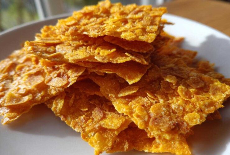 Close-up of golden, crispy cornflake crust pieces used for Crispy Baked Chicken Tenders.