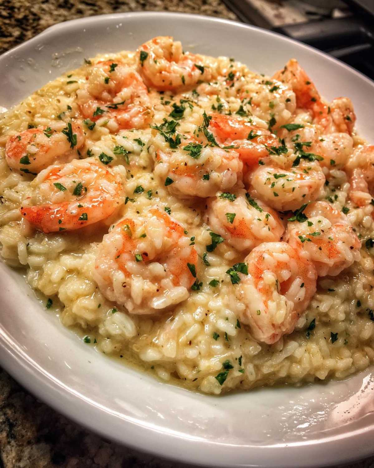 Creamy rice topped with plump shrimp and fresh parsley, representing the Garlic Butter Shrimp and Rice Skillet.