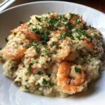 Creamy Garlic Butter Shrimp and Rice Skillet topped generously with fresh chopped parsley.