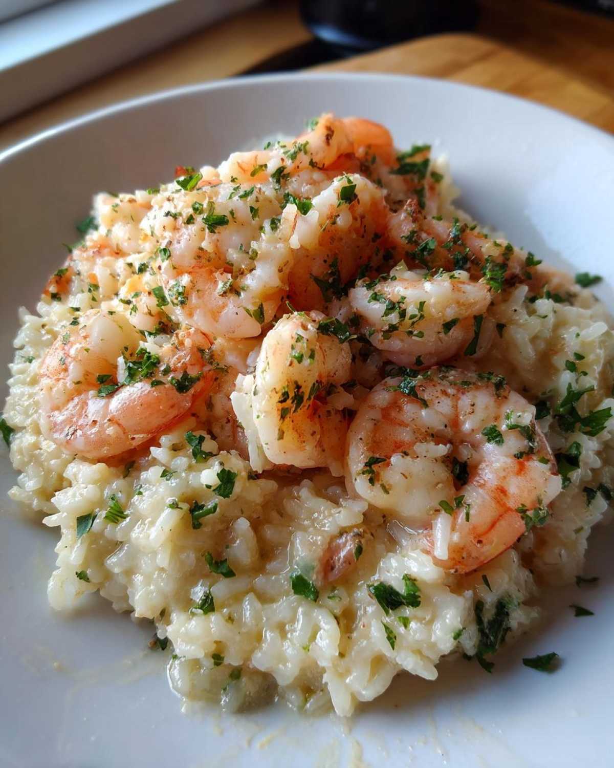 Close-up of creamy Garlic Butter Shrimp and Rice Skillet topped with fresh parsley.