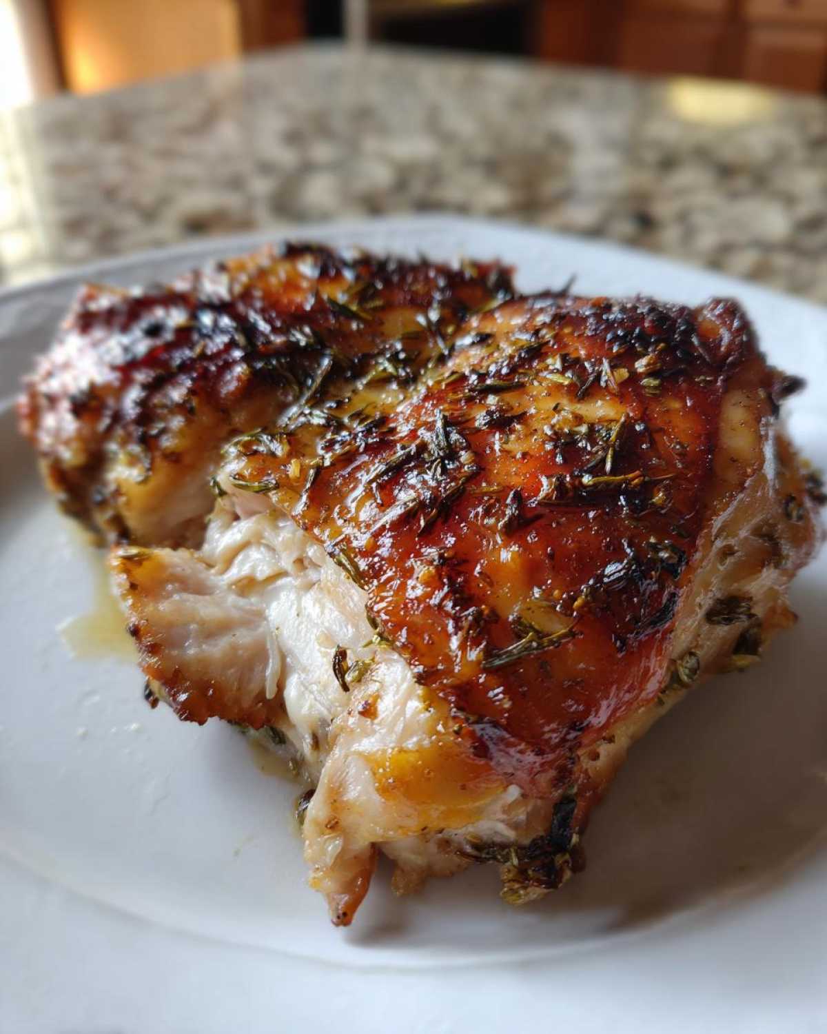 Close-up of juicy Lemon Garlic Roasted Chicken Thighs with crispy, herb-crusted skin.