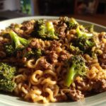A close-up of One-Pot Beef and Broccoli Ramen Noodles served on a light green plate.