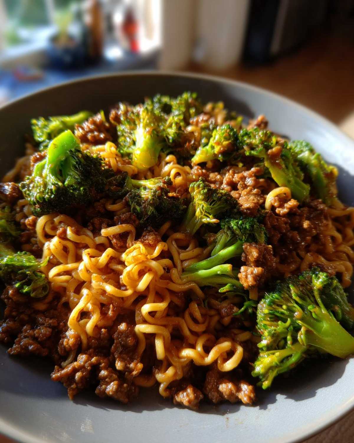 Close-up of One-Pot Beef and Broccoli Ramen Noodles mixed with ground beef and bright green broccoli florets.