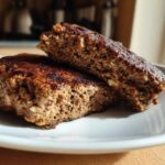 Close-up of a Smoky Black Bean Burger Patty cut in half, showing the moist, textured interior.