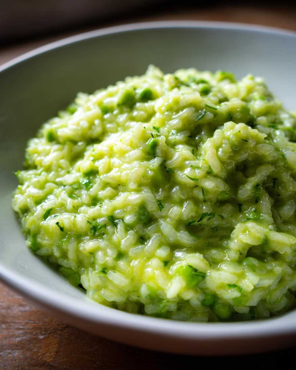 Close-up of creamy, vibrant green Spring Pea and Mint Risotto served in a light bowl.