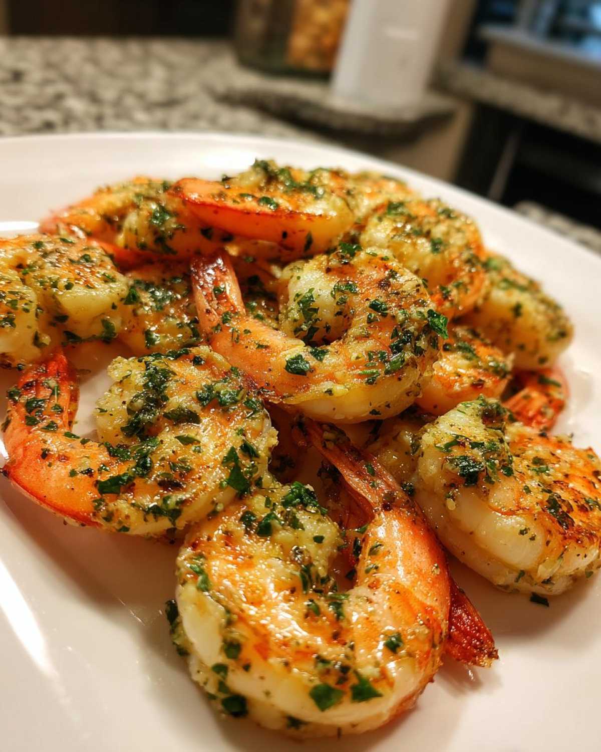 Close-up of perfectly cooked Air Fryer Crispy Garlic Butter Shrimp, glistening with butter and topped with chopped parsley.