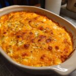 Close-up of a bubbly, baked cottage cheese buffalo chicken dip with a golden-brown melted cheese topping.