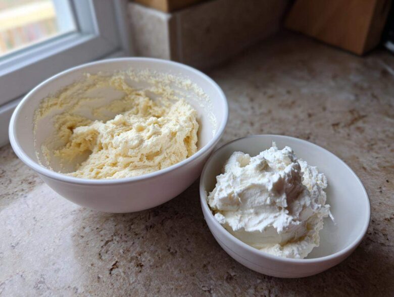 Two bowls showing ingredients for ies: one with creamed butter/sugar mixture and one with whipped cream filling.