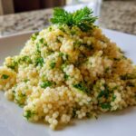 Close-up of Easy One-Pot Creamy Lemon Herb Couscous garnished with fresh parsley and lemon zest.