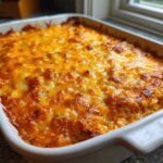 Close-up of a baked Keto Creamy Buffalo Chicken Casserole with a bubbly, golden-brown melted cheese topping.