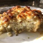 Close-up of a serving of Keto Creamy Garlic Parmesan Chicken Bake with a golden-brown cheesy top.