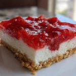 Close-up of a single serving of No-Bake Strawberry Pretzel Dessert Bars showing the pretzel crust, cream cheese layer, and strawberry topping.