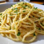 Close-up of One-Pot Creamy White Bean Lemon Pasta tossed in a light sauce and topped with fresh parsley.