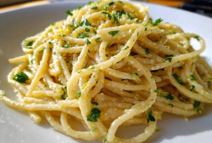 Close-up of One-Pot Creamy White Bean Lemon Pasta tossed in a light sauce and topped with fresh parsley.