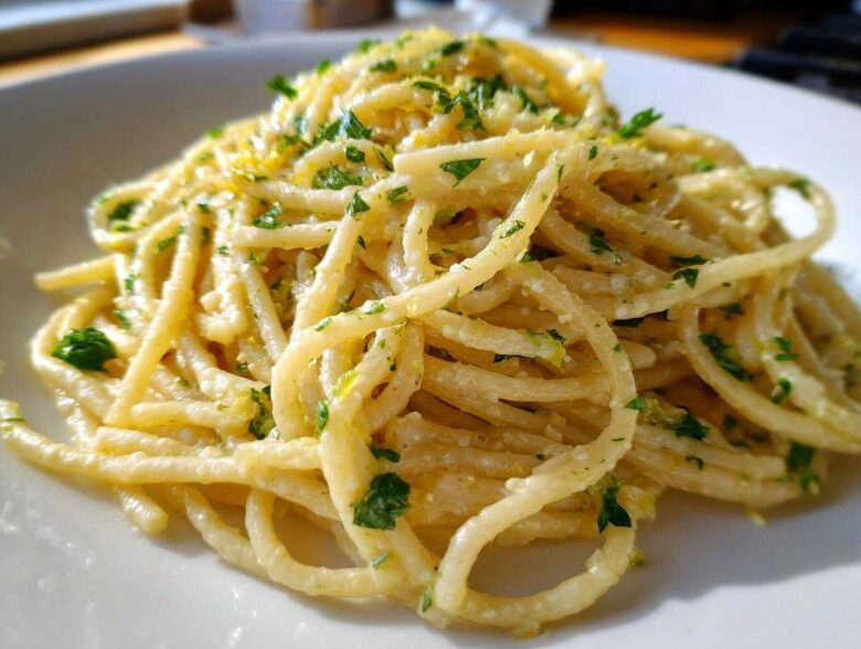 Close-up of One-Pot Creamy White Bean Lemon Pasta tossed in a light sauce and topped with fresh parsley.